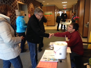 Derek Strohl greets attendees